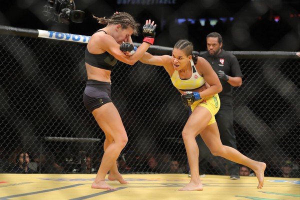 Amanda Nunes punches Miesha Tate during their fight at UFC 200 on July 9, 2016